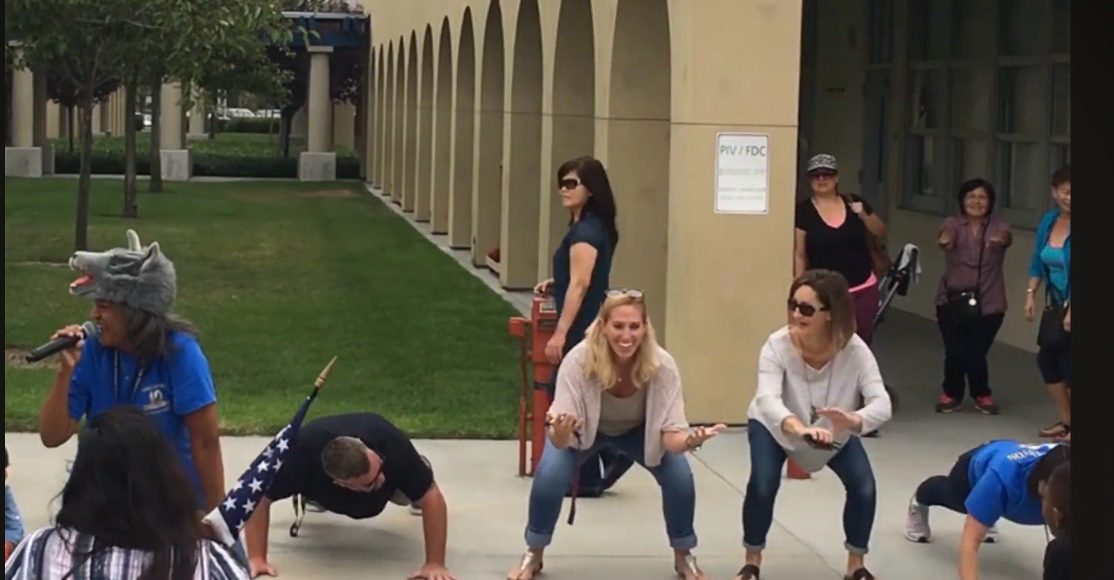 Outdoor fitness group doing squats and push-ups